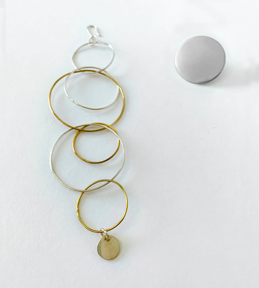 Asymmetric set of silver and yellow gold plated boho earrings.